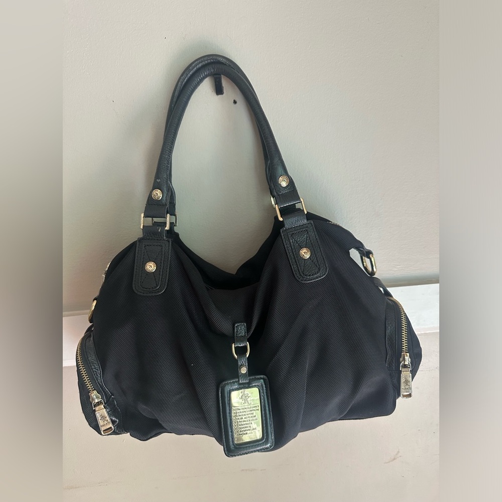 JPK Paris 75 black nylon shoulder bag, gold hardware and a branded luggage tag.